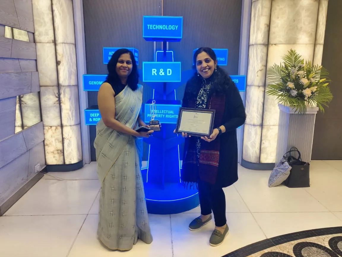 Two women holding the CII Innovations Award.