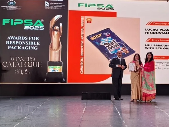 Person holding the FIPSA award trophy on stage.