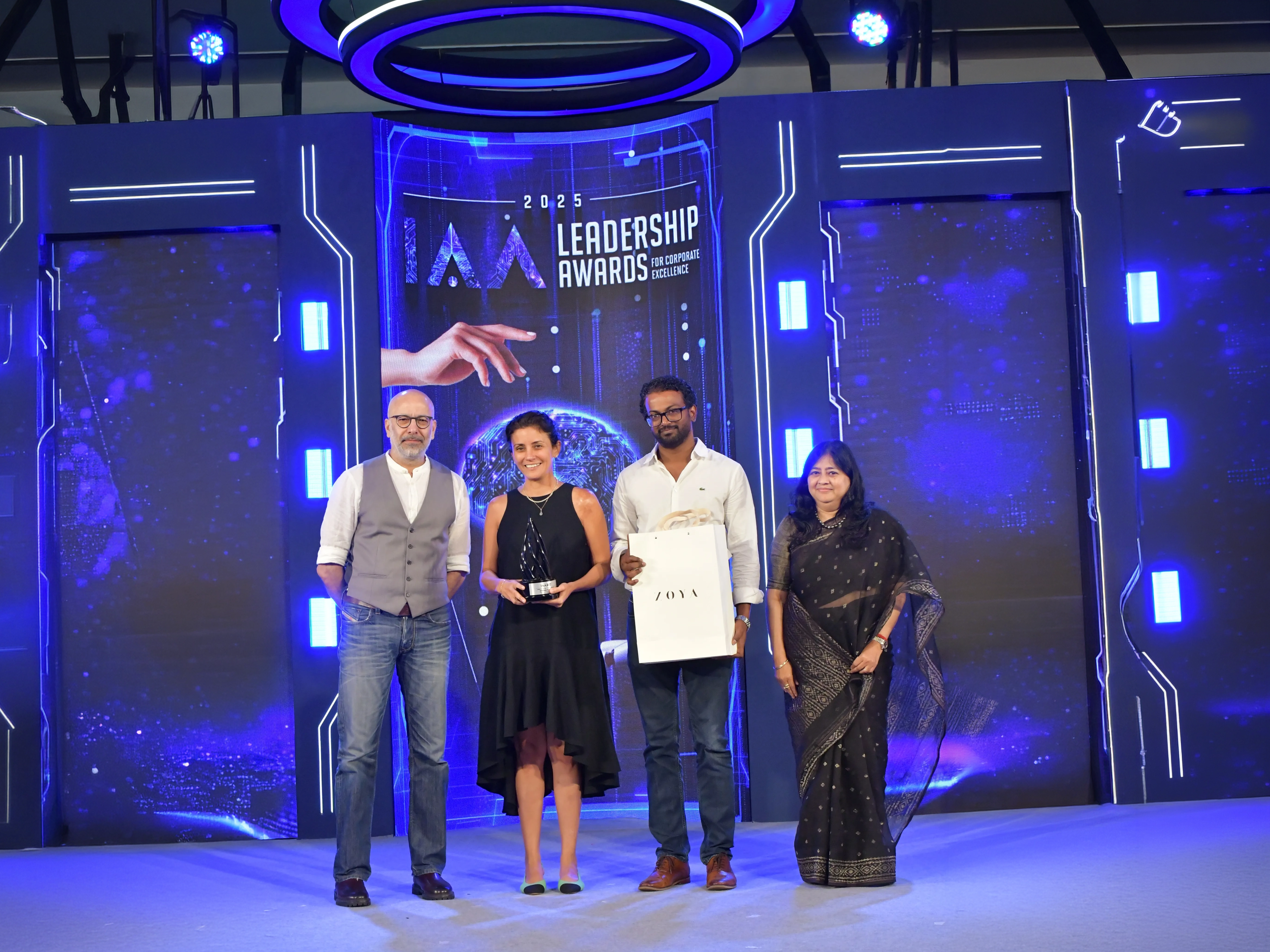 People on stage receiving the I A A Leadership Award.