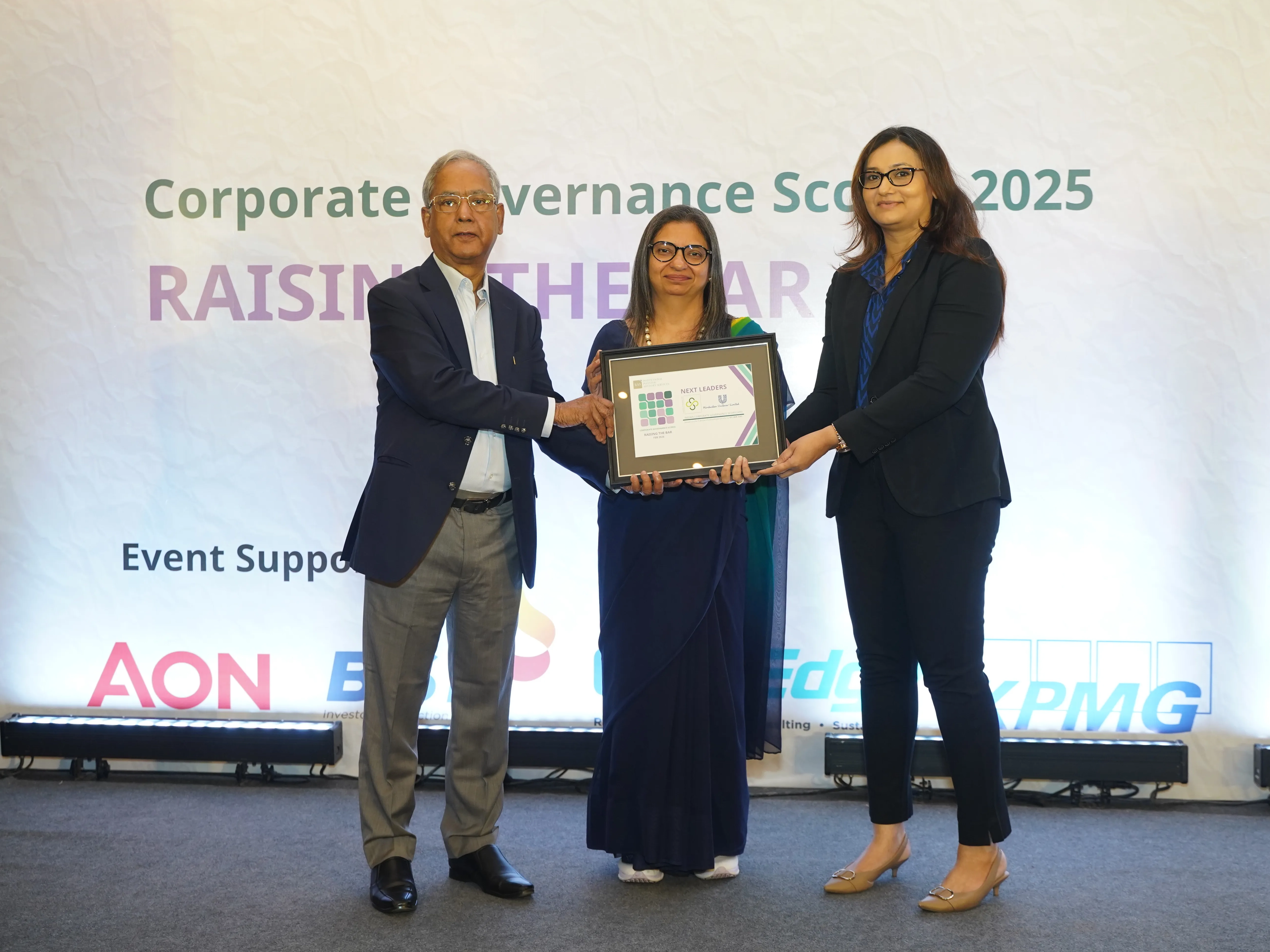 Two people holding the Next Leader Award certificate.