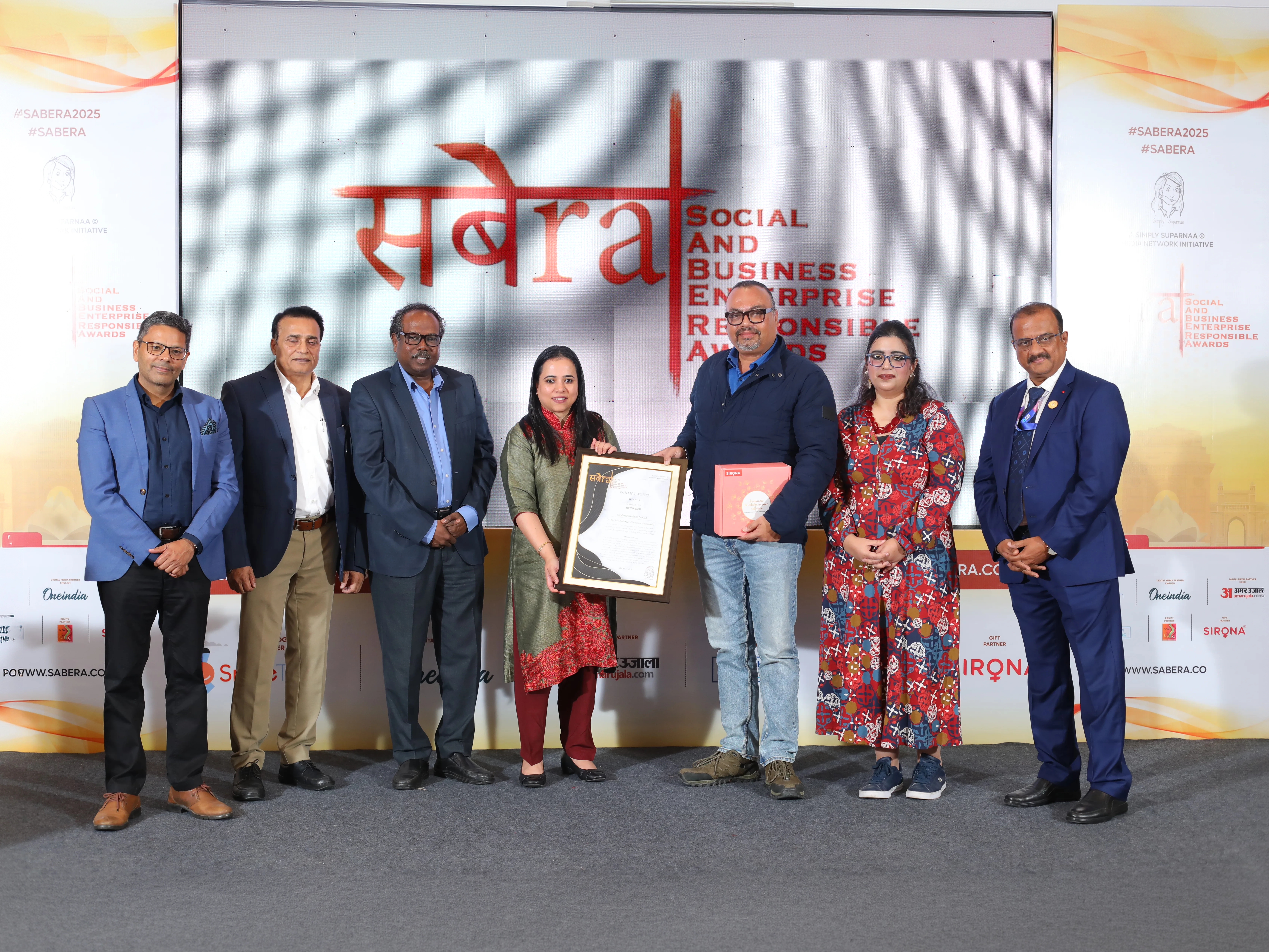 Group of people holding the SABERA award certificate.